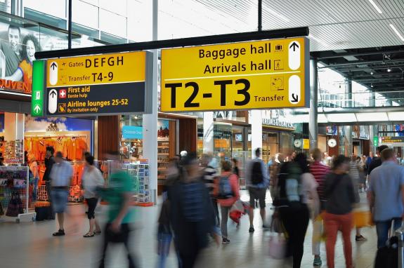 airport with gates number and people circulating