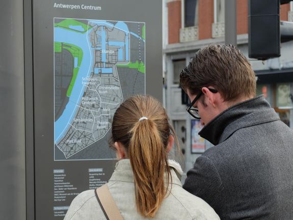 Couple of tourists using a city map